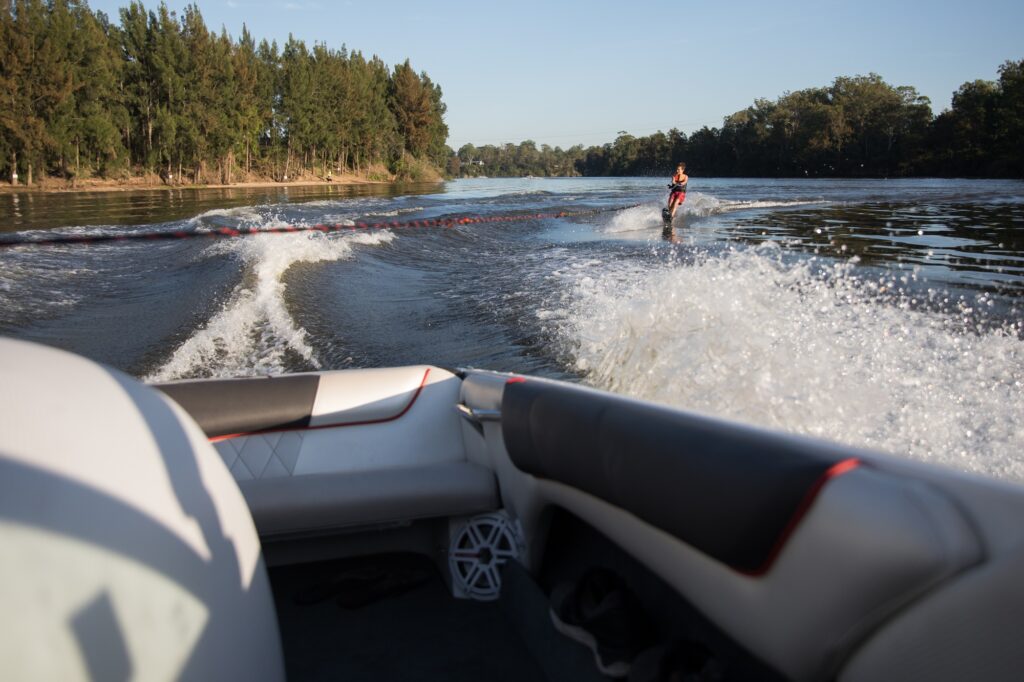 Boy waterskiing at sunrise